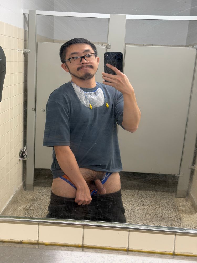 A gay man takes a nude, nsfw mirror selfie at work's washroom