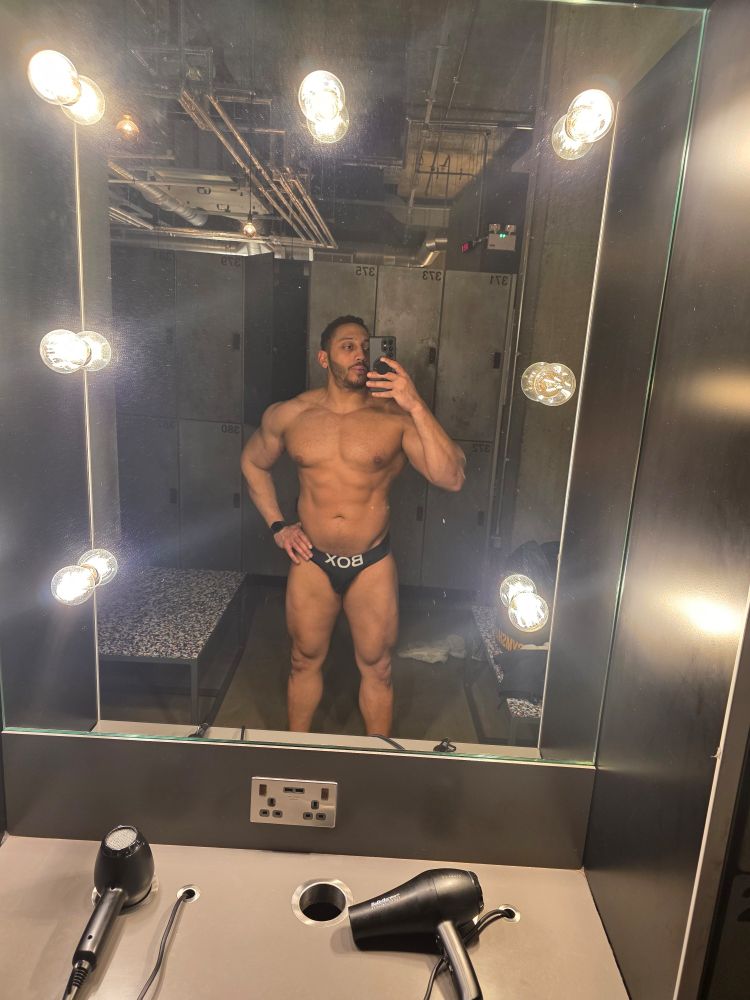 Standing in front of gym mirror in box briefs
