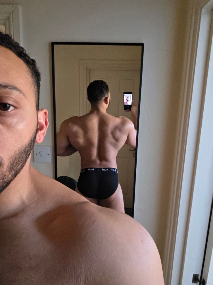 Back shot in mirror in black underwear. You can see my shoulders and part of my face to the left of the image. 