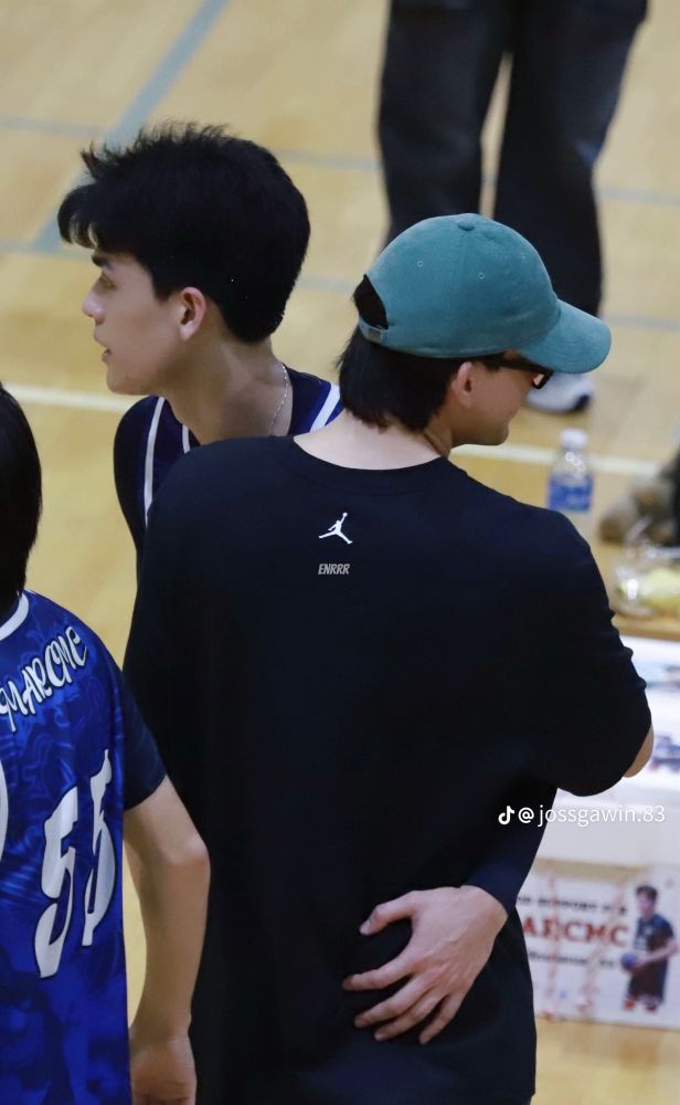 photo of joss and gawin at a basketball game, joss has his arm around gawins waist