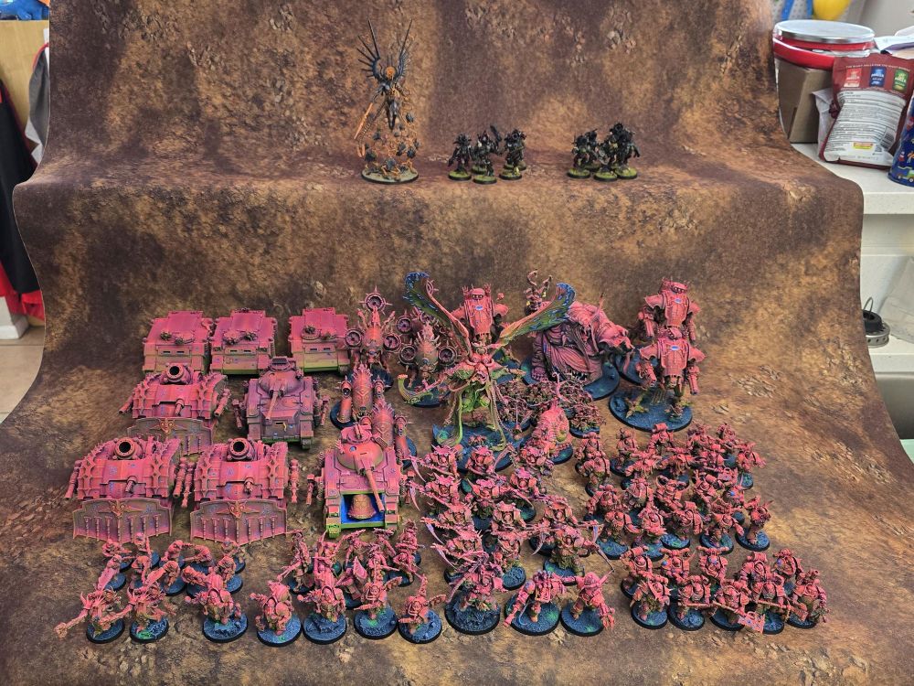 A picture of what I painted to completion this year. On the top level is the non-death guard stuff, while all the pink mass is the Death Guard and allies.
