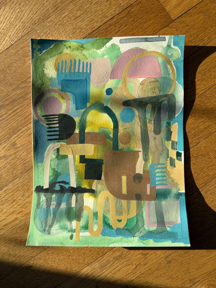 Four abstract artworks set on top of a warm wooden floor in the afternoon sun.