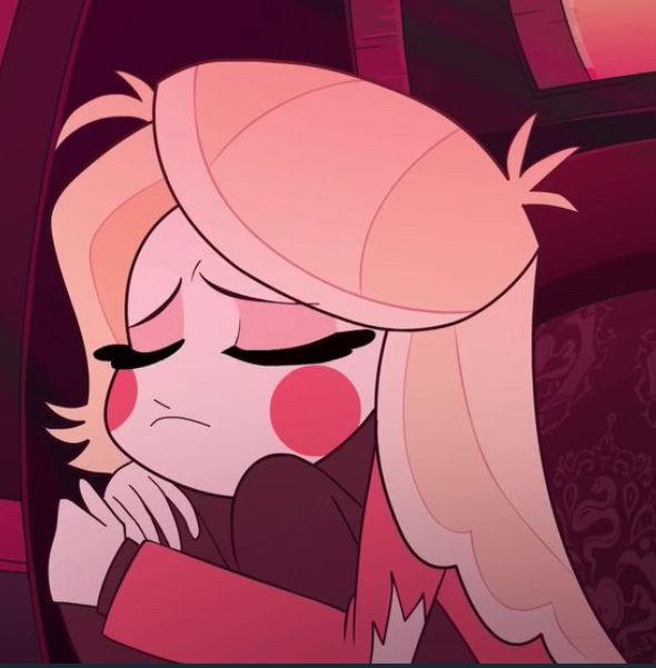 Screenshot of Pilot Charlie, curled into a ball and looking sad but adorable. Her cheeks look especially round and her hair is messy