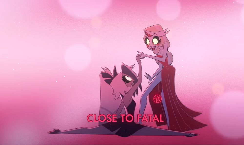 Vaggi dropping down into a split, her head roughly level with Charlie’s loin