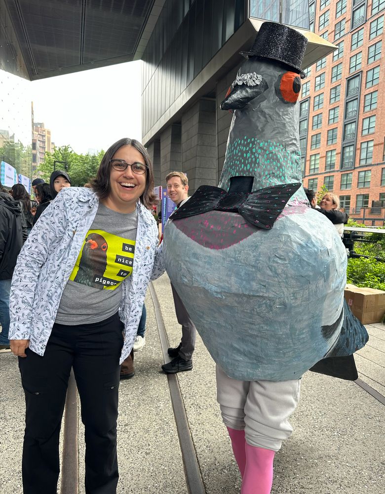 Me standing next to a person wearing a large costume of a pigeon in a top hat.