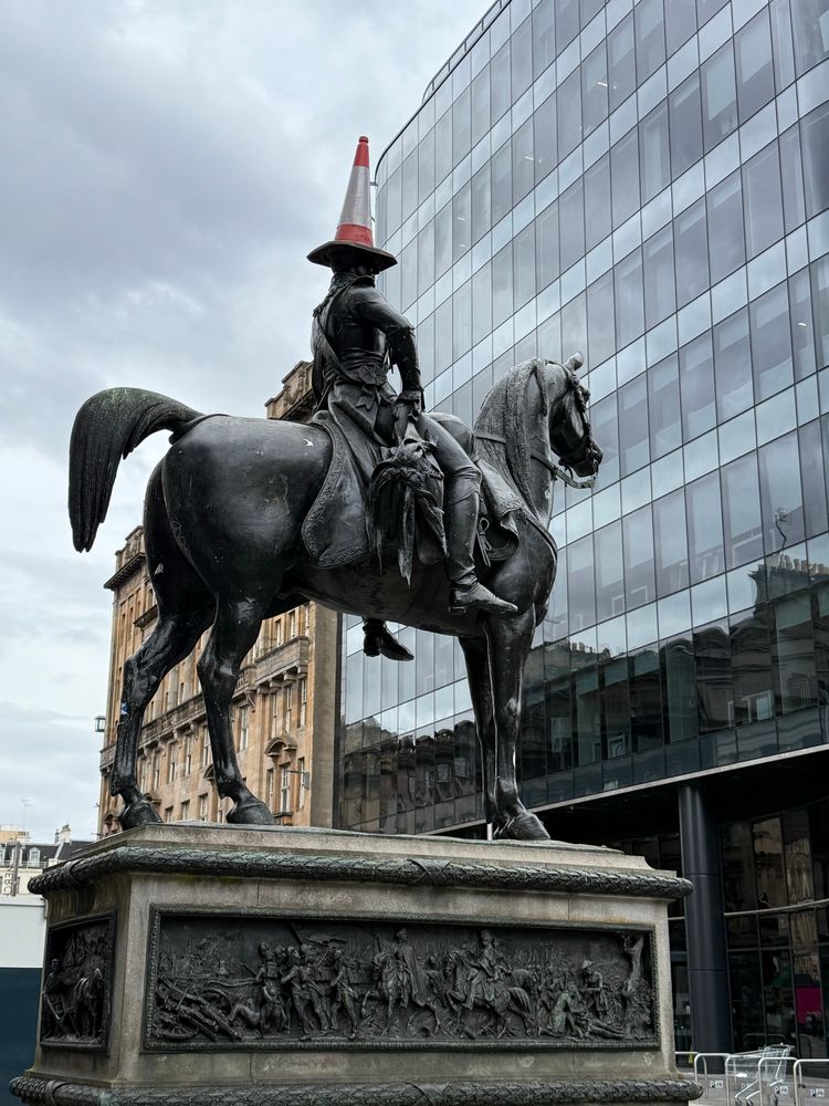 A statue in Glasgow: a highway cone on the head of the Duke of Wellington on a mighty steed. 