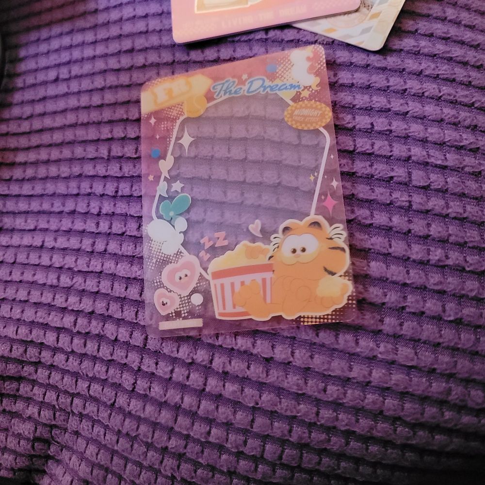 3 of 3, this seems to be a clear plastic cover card with a cute Garfield design. It has a clear middle so you can see whatever card you put underneath 