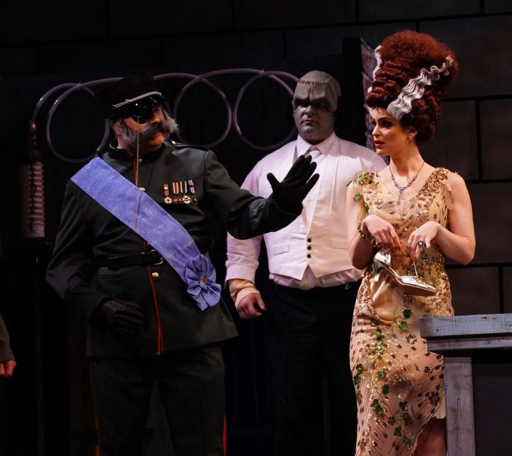 Still from a production of Young Frankenstein, the Musical featuring Inspector Hans Kemp, The Creature, and the Lovely Elizabeth Benning complete with the Bride hairstyle.