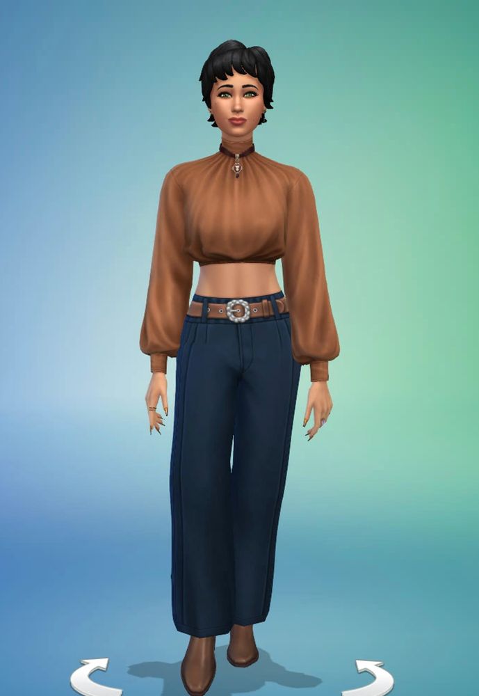 White female sim with the short shag hair from L&D in black. Shes got green eyes and is wearing mock-neck satin crop top in tan from L&D, matching tan zip up ankle boots from L&D & belted wide-legged pant in dark blue