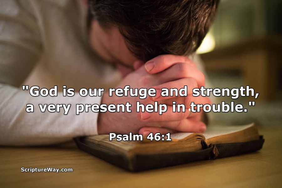 Man bowed and praying with folded hands on a Bible - "God is our refuge and strength, a very present help in trouble." - Psalm 46:1 - 123RF Photo - Used under license