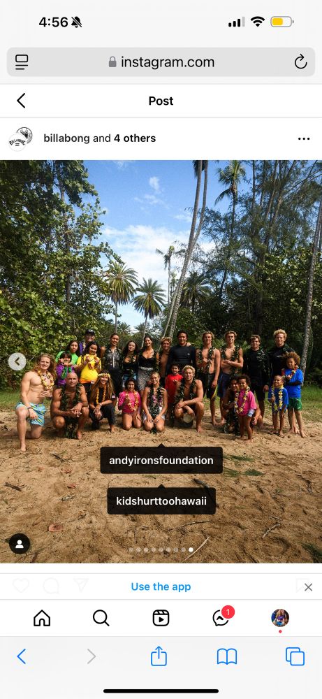 Group photo of surfers and kids on the beach