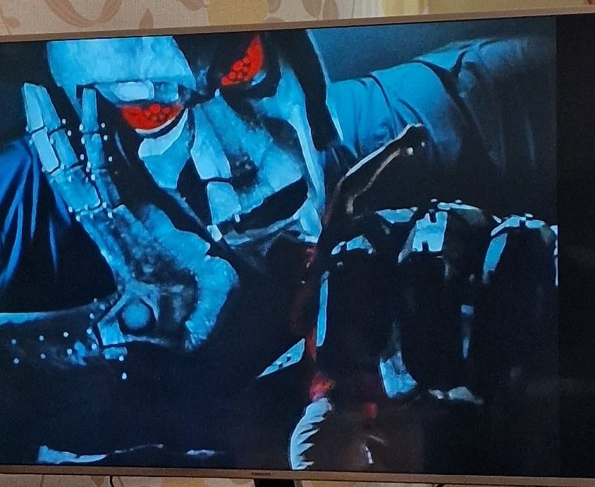 Lord Dark, a giant stone statue with glowing red eyes, rests with his hand on his chin.