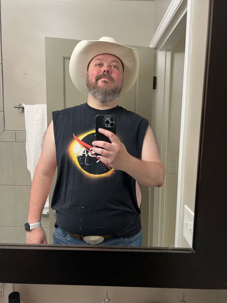 Man in cowboy hat and stringer tee