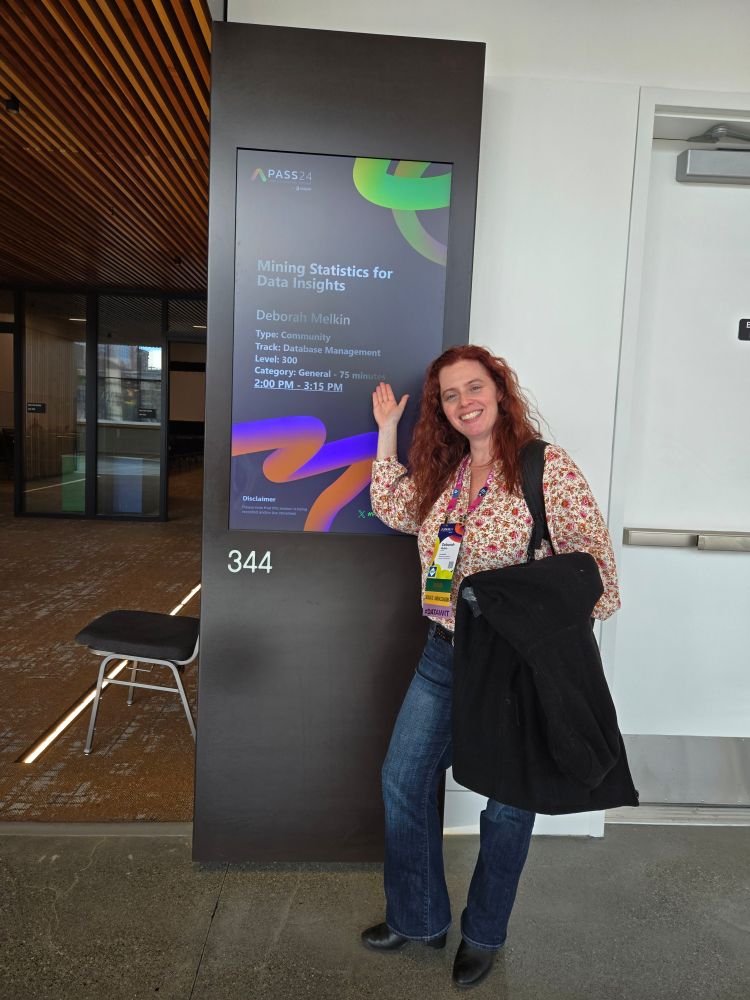 Me standing in front of the sign of the room for my session 
