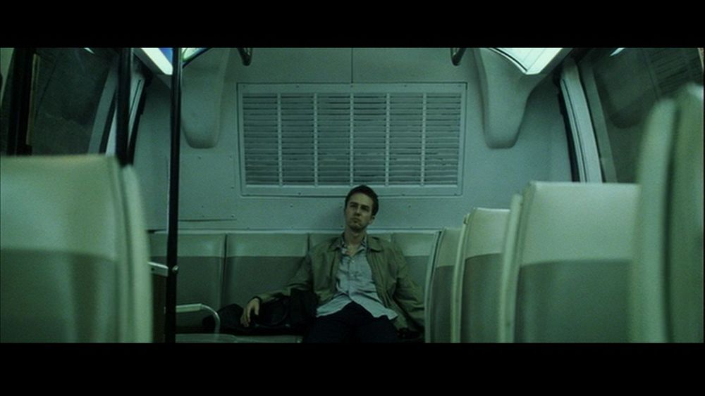 Edward Norton as the narrator in Fight Club (1999). He is sitting on a bus. But now the bus is free because at night you are Zohran Mamdani (well known Linkin Park fan) and you have made them free.