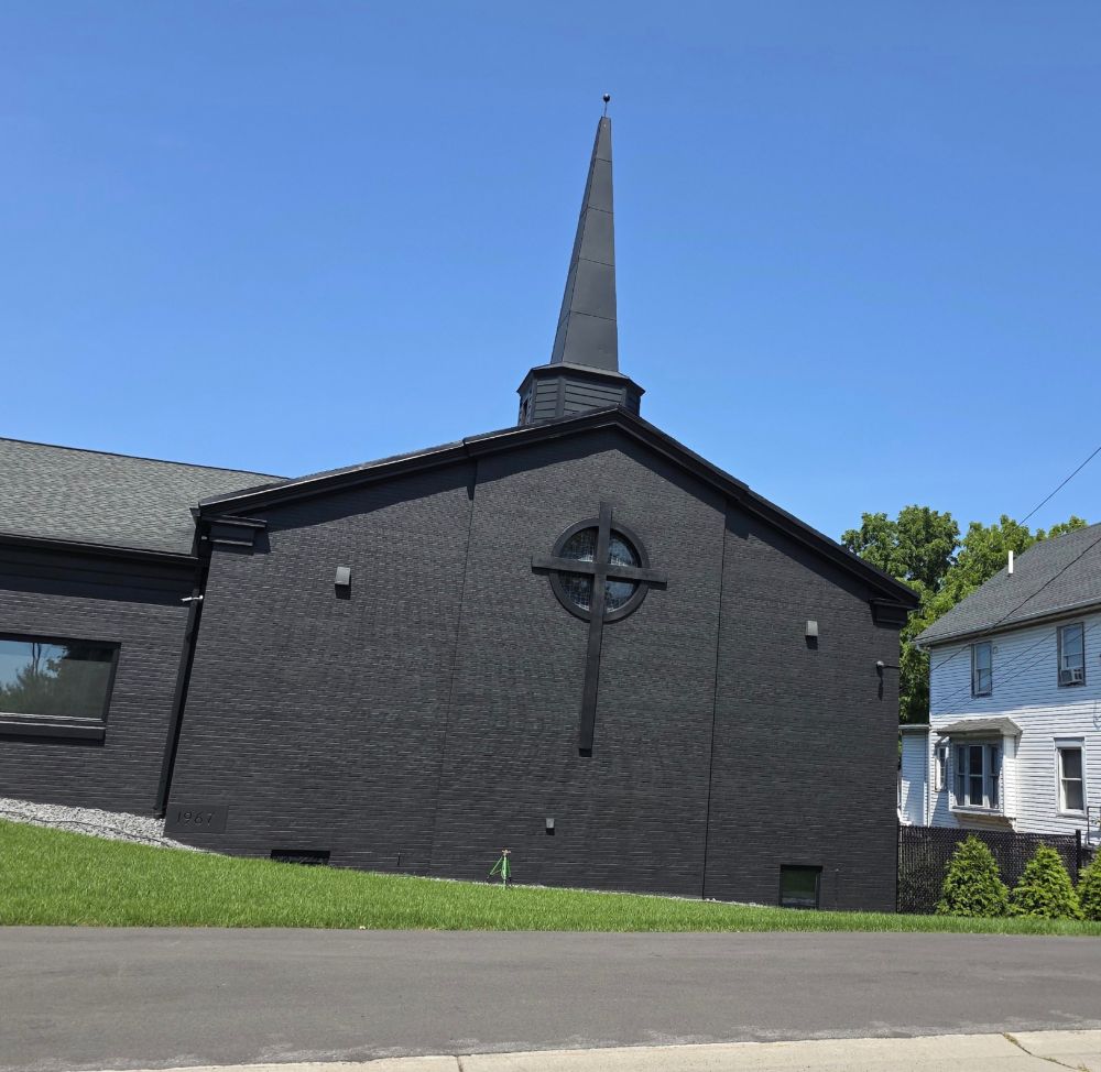 It's a church...painted black - a large cross design on the exterior wall has windows inside a circle around the center of the cross. All black (the windows are not painted).