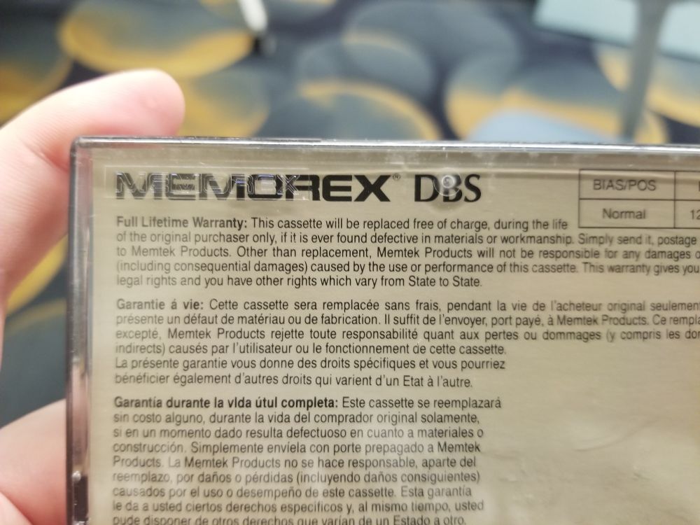 a Memorex brand tape case with fine print saying it is able to be replaced free of charge at any time during my grandma's lifetime