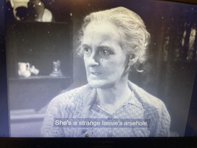 Still from the 1941 film "Love on the Dole", with the unfortunate subtitle "She's a strange lassie's arsehole".
