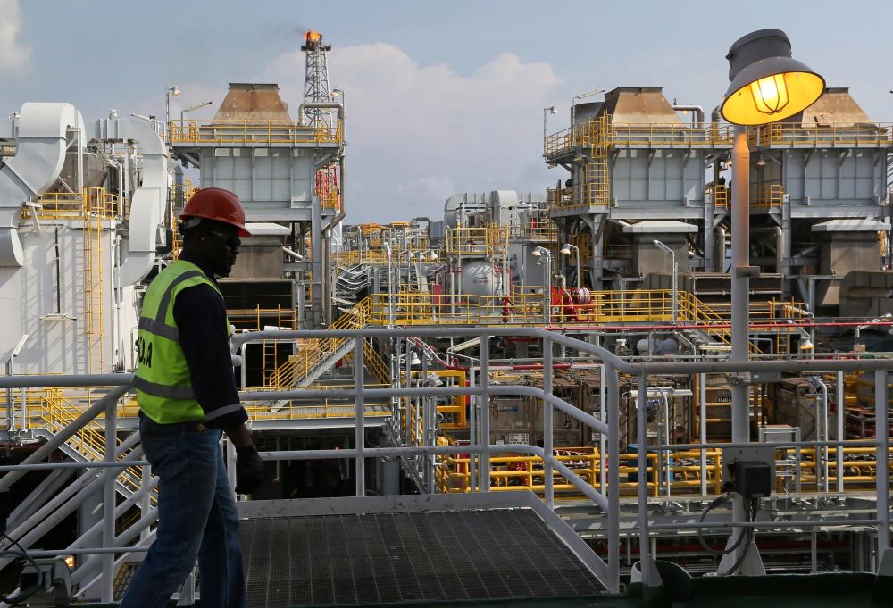 An oil worker walks along the deck aboard a floating production, storage and offloading vessel in the Agbami deepwater oilfield in Nigeria.