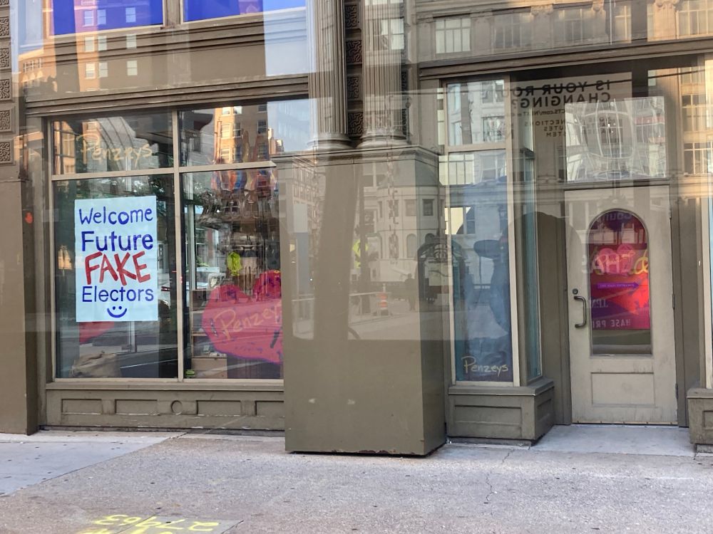 A poster in the windows of the downtown Milwaukee Penzey’s on July 13, 2024, reads, “Welcome Future FAKE Electors :)” reminding the reader of Wisconsin’s Republican 2020 fraudulent electoral college electors who committed once of the rarest forms of voter fraud - electoral college elector fraud - when they gathered in Wisconsin Capitol building in December 2020 with the help of now Rep. Scott Fitzgerald who’s office helped them secure a room in the building to cast a fraudulent slate for Donald Trump. The crime is currently unpunished.