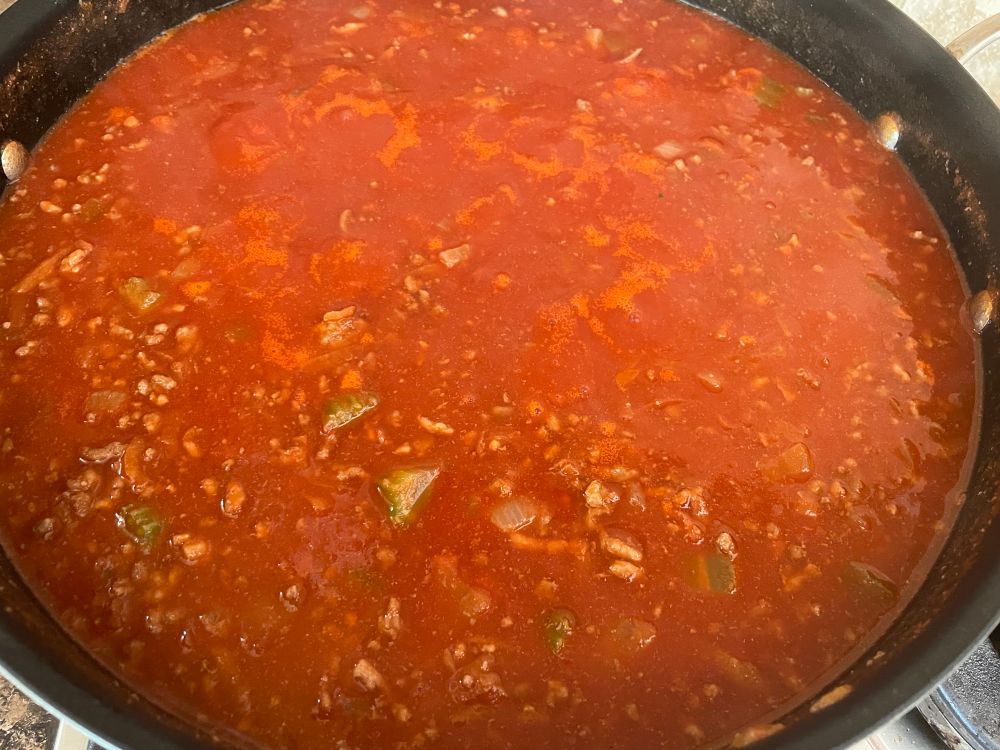 A ragu sauce at the start of a simmer.