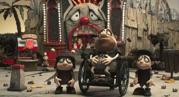 Scene from Memoir of a Snail of the two main leads (twins) and their father in a theme park.