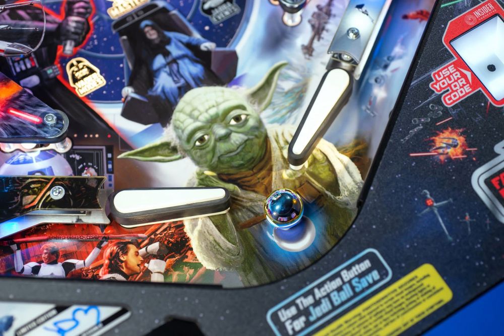 A picture of Yoda between the pinball flippers, looking very bored.