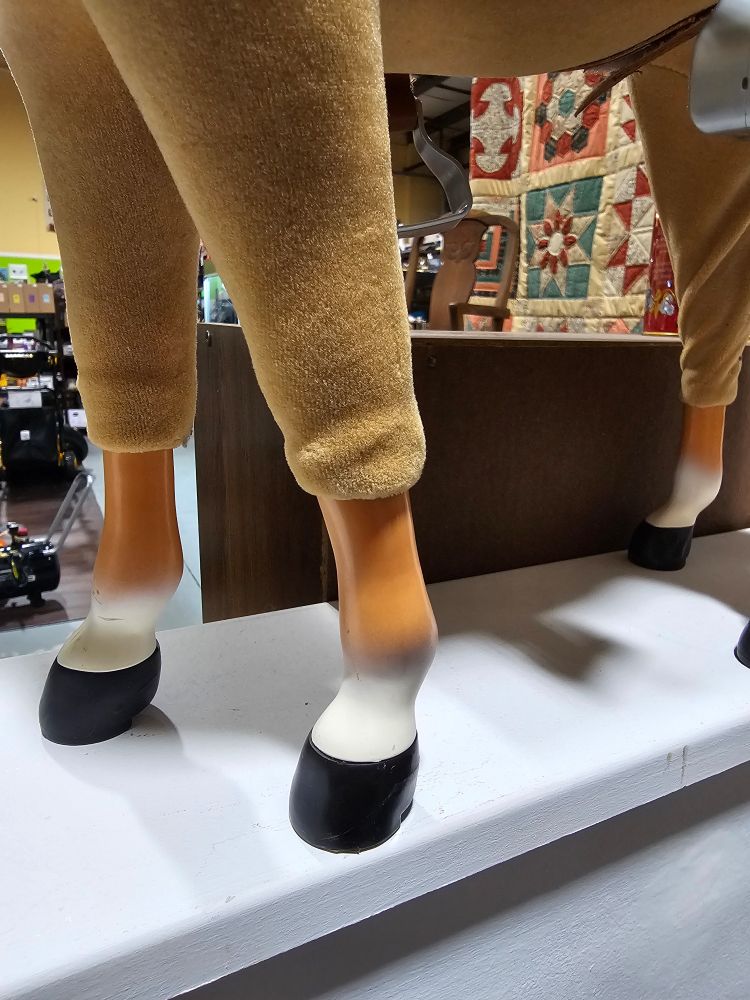 Closeup of plastic horse wearing a horse pelt.