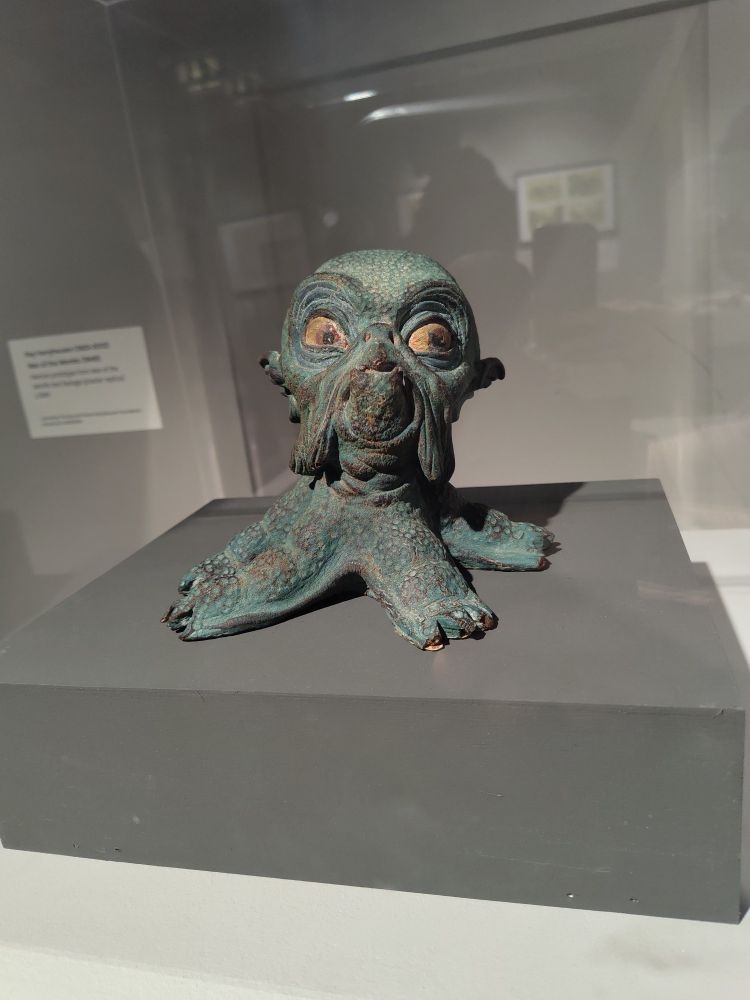 A model of an alien that looks like an octopus with only four legs, a bulbous head, big eyes, and jowels

