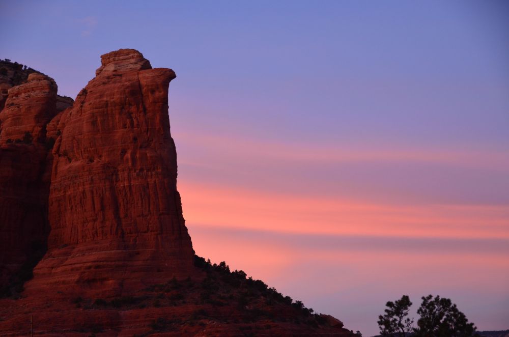 Orange rock, the top shaped like an eagle head, pink sunset beyond {copyright M. Frost}
