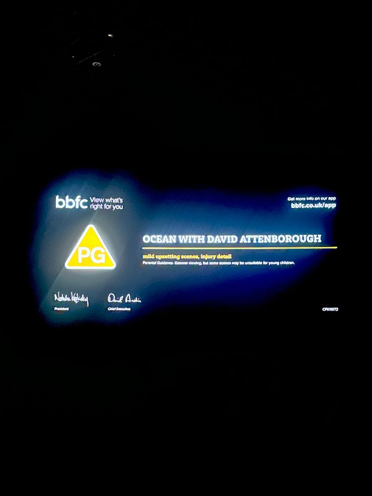 photo of a cinema screen just before 'ocean' with david attenborough played, showing the title of the film and brief information about the film's age rating (pg) 