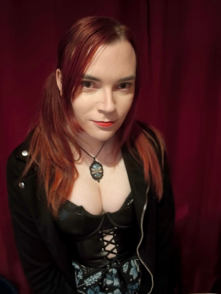 She has long red pigtails, red lipstick and a lot of cleavage.