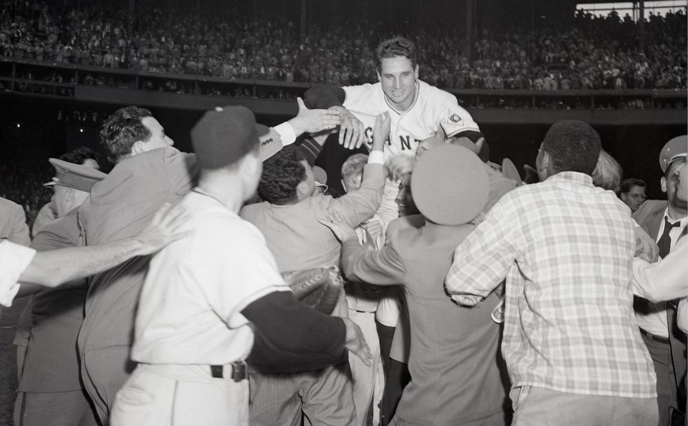 Fans and players lifting Bobby Thomson off the ground after hitting The Shot Heard Around the World.