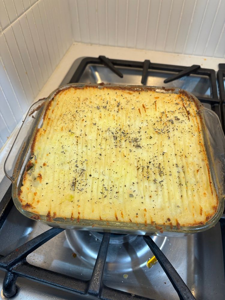 A cottage pie topping with scored lines and crispy edges 