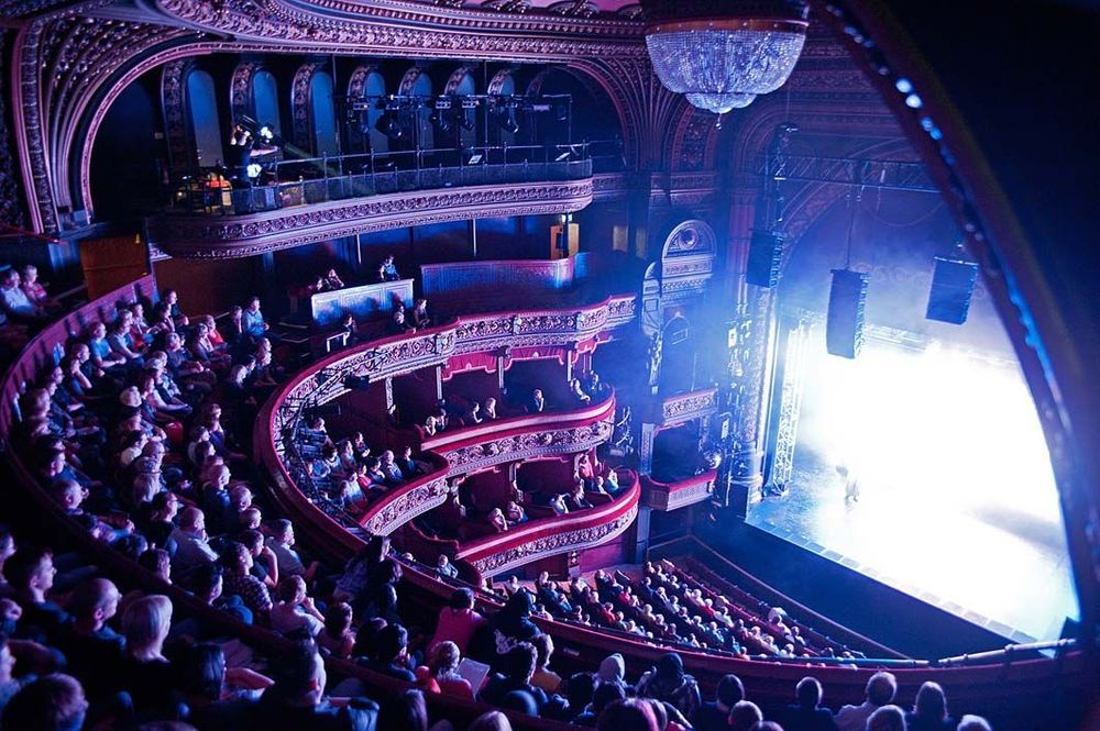 Full audience in large historic auditorium at Leeds Grand, viewed from the upper circle.