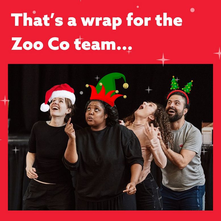Image on red background, text reads "That's a wrap for the Zoo Co team.". Below four actors in rehearsal look up at the message with excitement - three of them have a santa hat, elf hat and christmas tree headband photoshoped onto their heads.