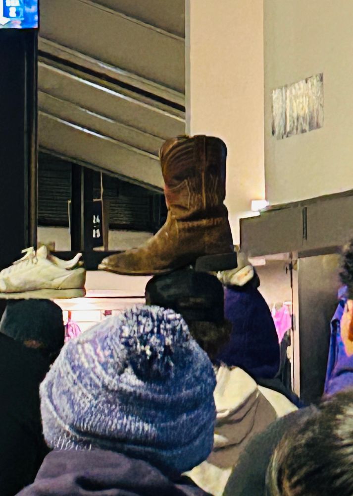 UW fans watches the Mariners game in the main concourse of Husky Stadium while placing a Rally Boot on his head for luck. It eventually worked. And the Huskies won! GoMs🔱 