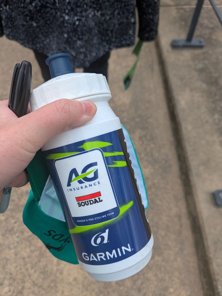 A picture of a white, blue and green AG Insurance Soudal cycling team water bottle 