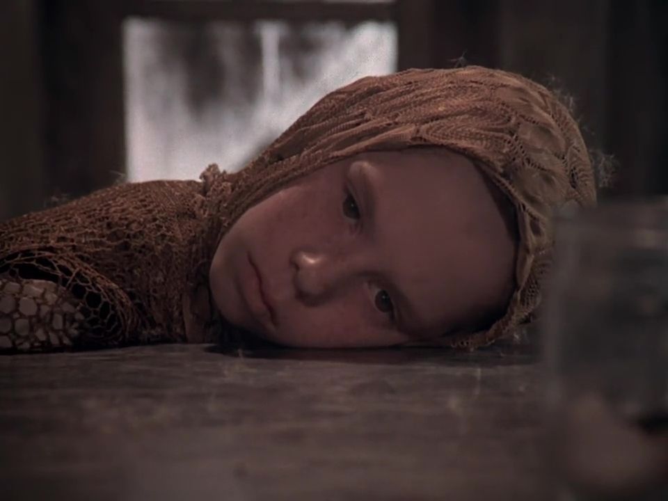 Young woman staring vacantly with her head on a table