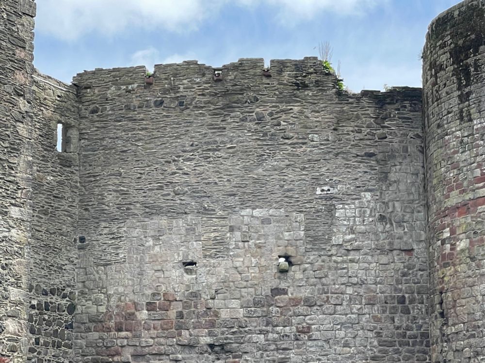 A particularly exciting feature is that the curtain wall was heightened in the 15th-16th century when the Gatehouse was rebuilt and extended. This has preserved the original crenellations, with the crenels infilled using a darker stone rubble contrasting with the lighter ashlar masonry of the earlier curtain wall.