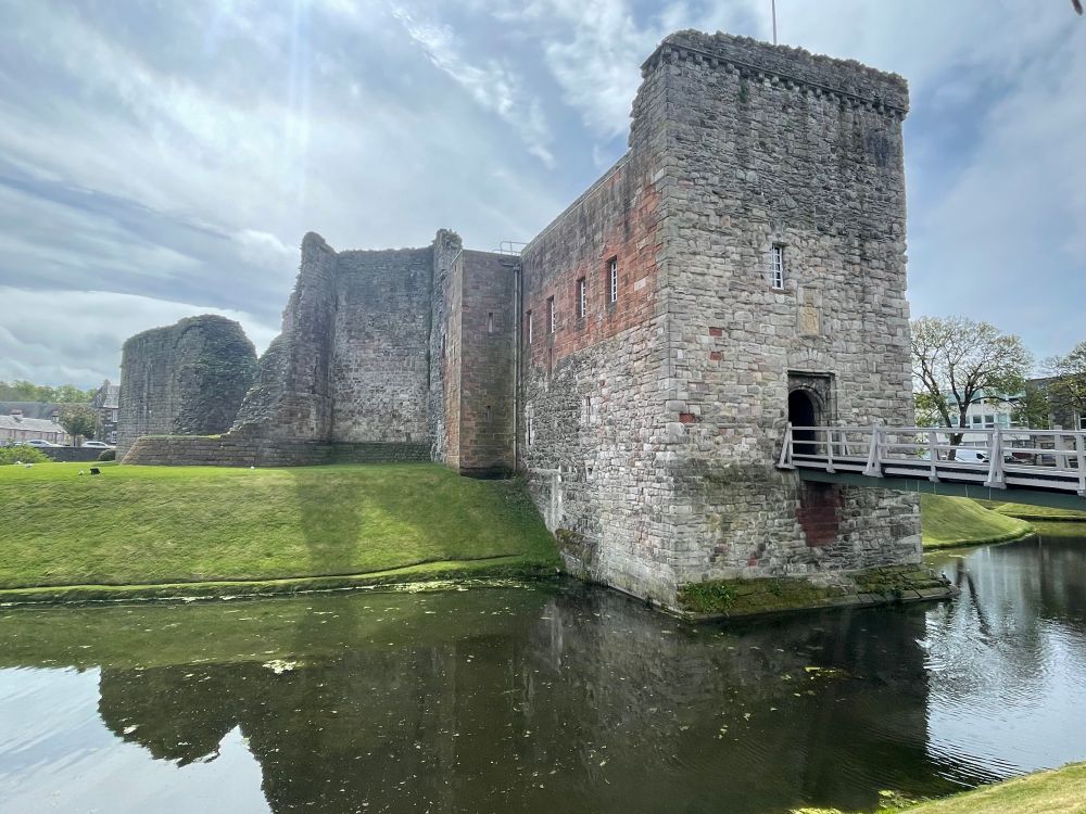 A view of the main entrance to Rothesay Castle. The original gate was massively extended outwards in the 15th-16th century to create a fine new suite of accommodation. The use of red sandstone marks the 19th century restoration work by that inveterate castle rebuilder the 3rd Marquess of Bute.