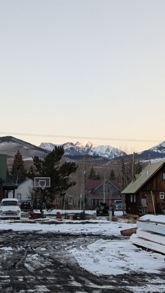 View of a snowy town with mountain range in the background