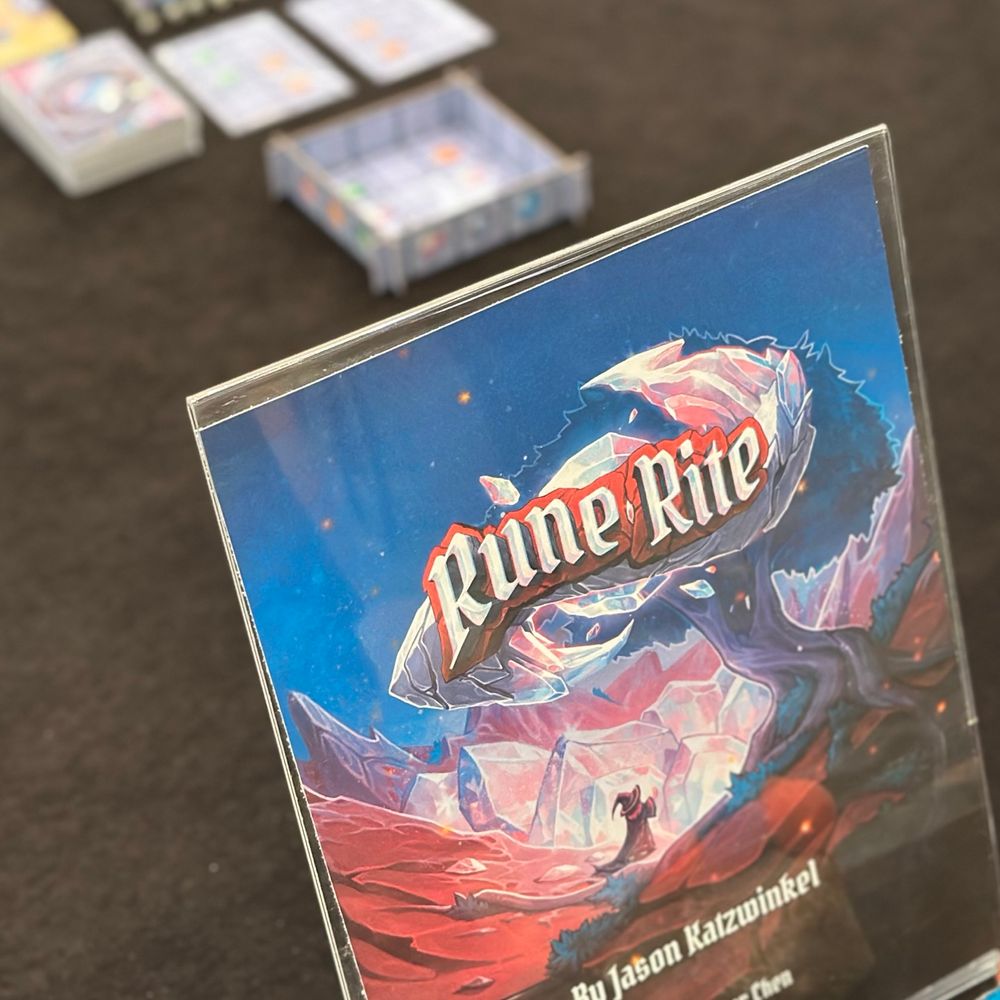 A Rune Rite standee on a demo table.