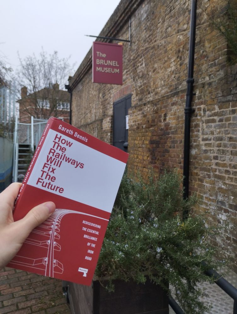 Me holding 'how railways will fix the future' outside the Brunel museum - where it was launched.