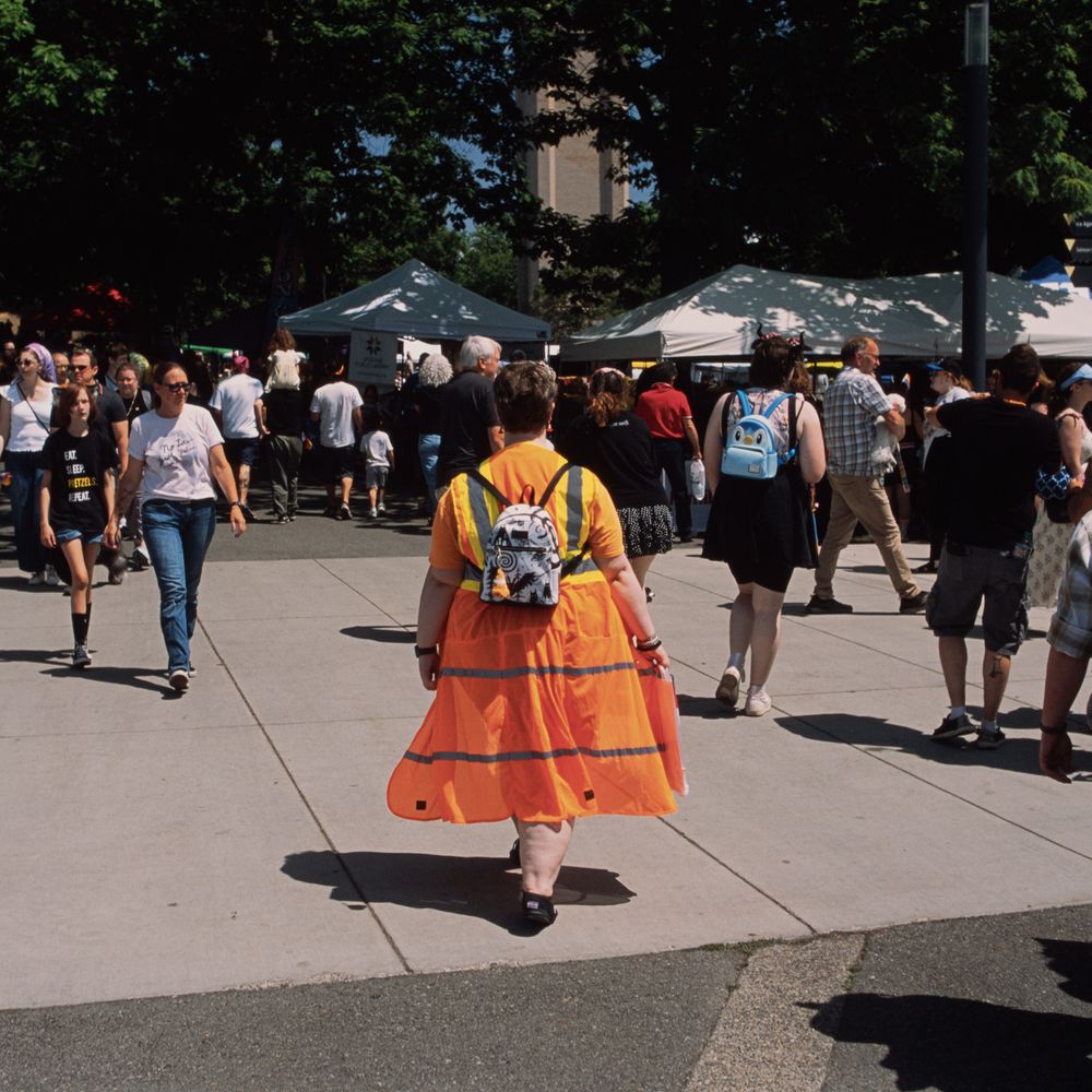 someone walking with a dress made out of orange and yellow road construction type of material