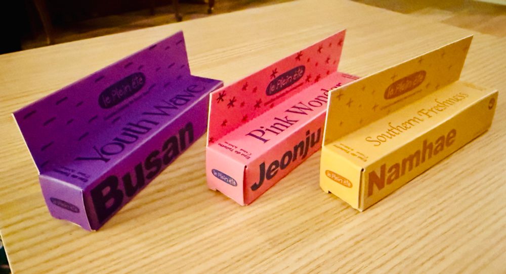 A photo of Youth Wave in a purple box, Pink Wonder in a pink box, and Southern Freshness in a yellow box.