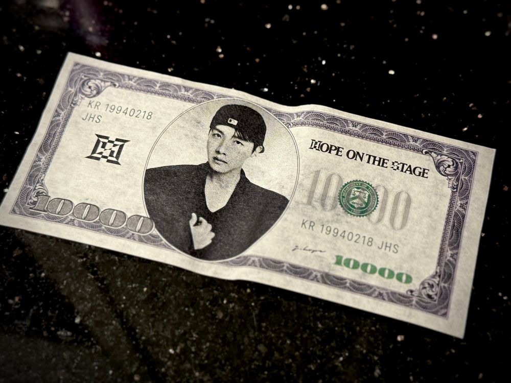 One of the fake $10,000 bills from the Hope on the Stage tour ft. Hobi in a backwards cap. 