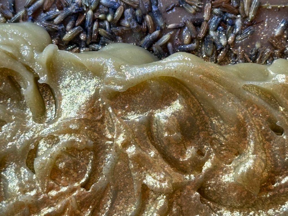 Wet cold process soap, tops with eco-friendly glitter, and lavender buds