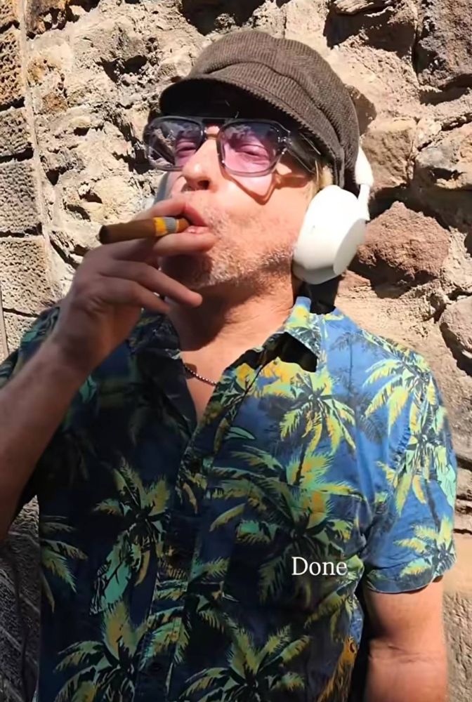 rhys darby w/ a cigar in his mouth 