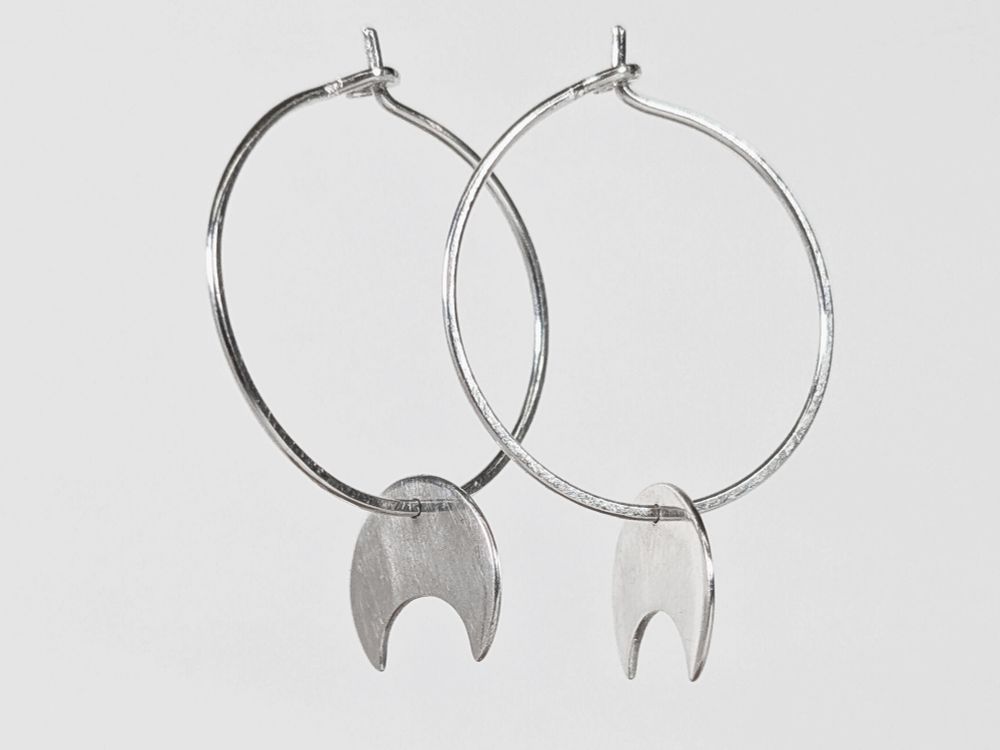 Sterling silver hoop earrings with tiny crescent moons